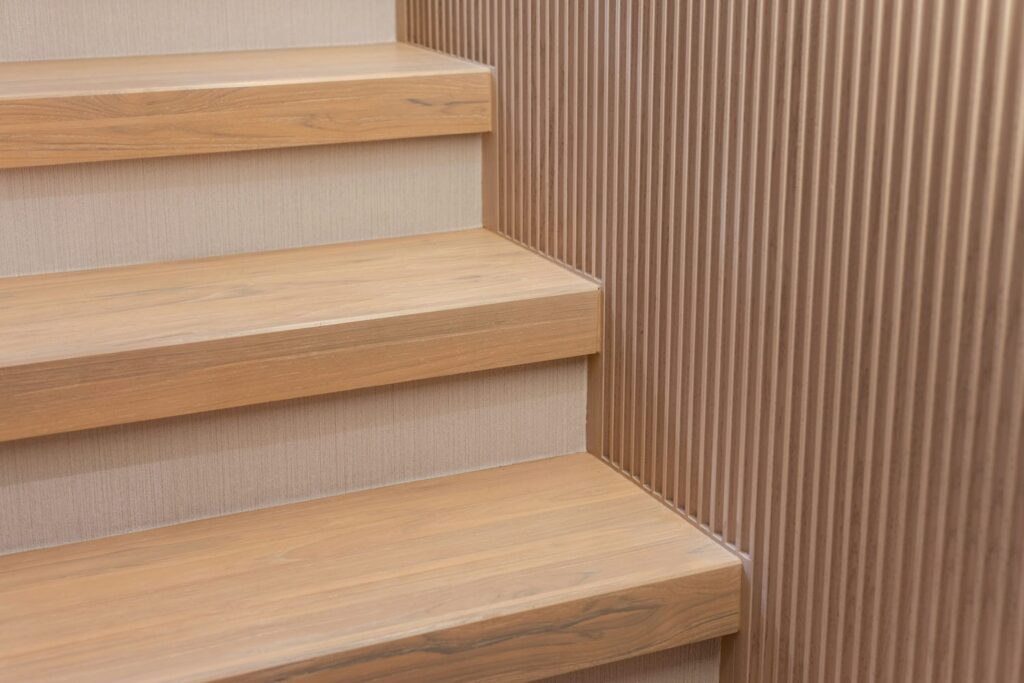 Close-up of stair tread and riser finish details during final inspection 