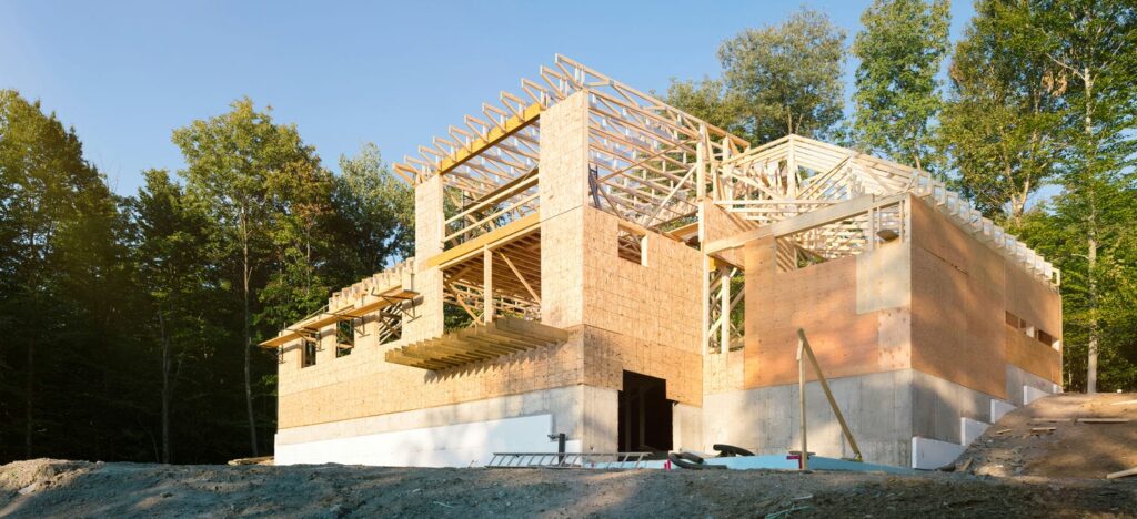 Custom home framing with large openings and open-concept layout that reduce available shear wall length