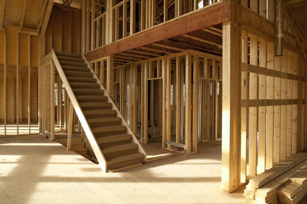 Tall double-height framed volume in a custom home, showing what makes luxury framing different