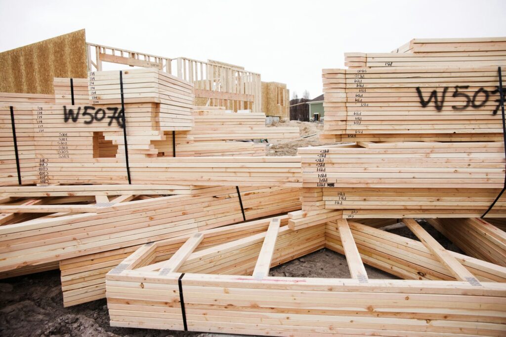 Factory-manufactured panelized framing components with shop drawing identifiers delivered to a custom home site