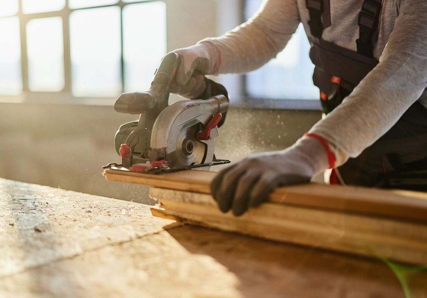 carpentry subcontractor cutting wood plank